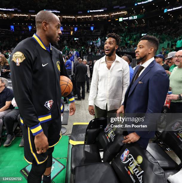 Andre Iguodala of the Golden State Warriors talks with former player, Evan Turner and CJ McCollum of the New Orleans Pelicans during Game Three of...