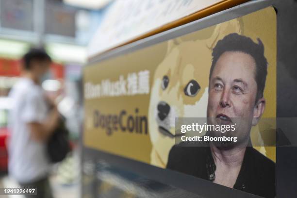 Sticker advertising Dogecoin on a cryptocurrency automated teller machine at a laundromat in Hong Kong, China, on Thursday, June 9, 2022. Tesla Inc....