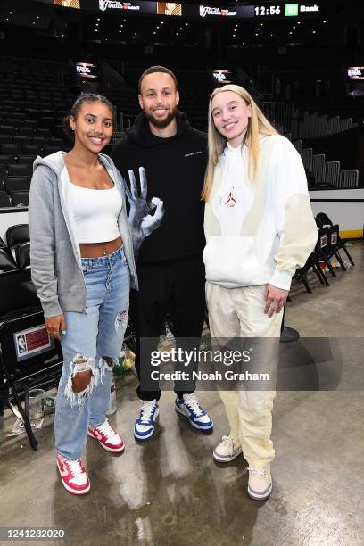 Stephen Curry of the Golden State Warriors poses for a photograph with UCONN players, Paige Bueckers and Azzi Fudd after Game Four of the 2022 NBA...