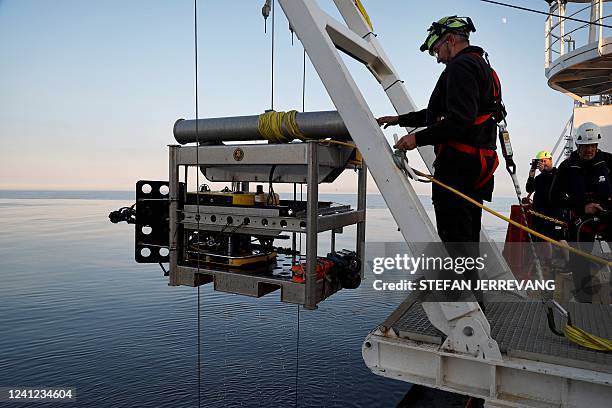 Photo taken on June 10 shows a ROV being lowered from the vessel Vos Sweet to the Baltic Sea during investigation work into the wreck of the MS...