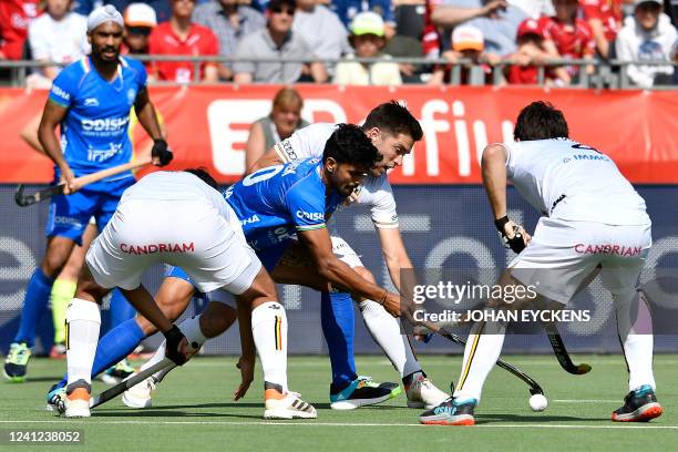 India's Amit Rohidas and Belgium's Cedric Charlier fight for the ball during a hockey match between the Belgian Red Lions and India in the group...