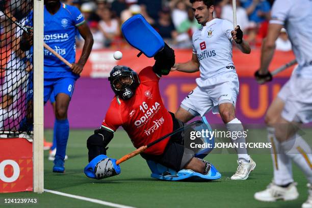 India's goalkeeper P. R. Sreejesh fights for the ball a hockey match between the Belgian Red Lions and India in the group stage of the Men's FIH Pro...