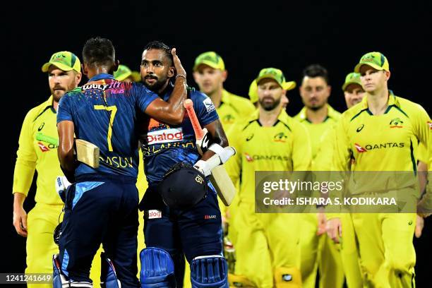 Sri Lanka's captain Dasun Shanaka celebrates with teammate Chamika Karunaratne after winning the third and final Twenty20 international cricket match...