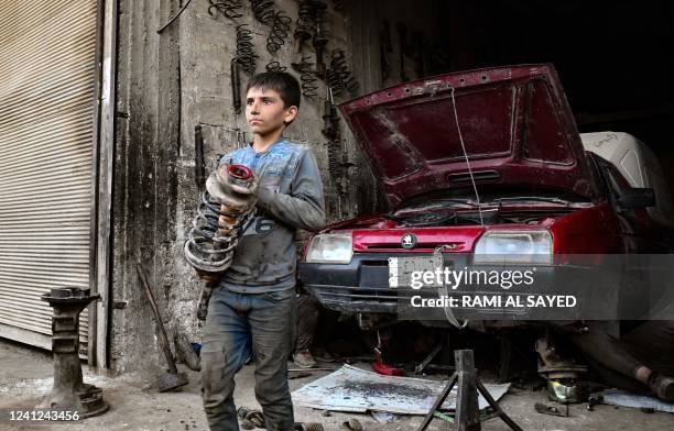 Young Syrian boy works at a car repair shop in the town of Jandaris, in the countryside of the northwestern city of Afrin in the rebel-held part of...