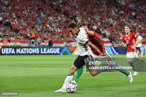Hungary's defender Willi Orban and Germany's midfielder Jamal Musiala vie for the ball during the UEFA Nations League football match Hungary v...