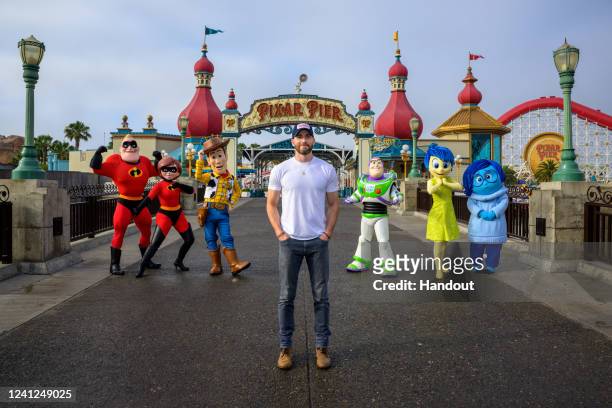 In this handout photo provided by Disney Resorts, actor Chris Evans poses with Disney/Pixar Animation characters during a visit to Disney's...