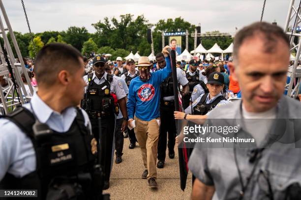 The United States Park Police escort a counter protester to a designated counter protest area as anti-gun violence demonstrators gather on the...