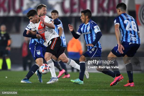 Julian Alvarez of River Plate fights for the ball with Cristian Menendez of Atletico Tucuman during a match between River Plate and Atletico Tucuman...