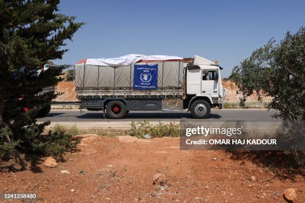 Truck carrying aid packages from the World Food Program drive through the town of Saraqib in the northwestern Idlib province on June 12, 2022.