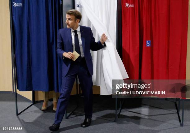 France's President Emmanuel Macron leaves the polling booth to casts his vote in French parliamentary elections at a polling station in Le Touquet,...