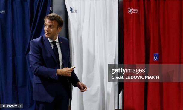 France's President Emmanuel Macron enter in the polling booth to casts his vote in French parliamentary elections at a polling station in Le Touquet,...