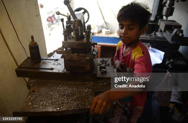 Year-old Pakistani Azlan Khan is seen busy working on a large machine at a shop in Karachi, Pakistan as the whole world observes the World Day...