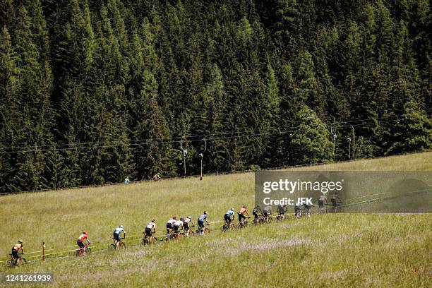 The pack rides during the Men's Cross Country Olympic Competition of the UCI Mountain Bike World Cup in Leogang, Austria, on June 12, 2022. - -...