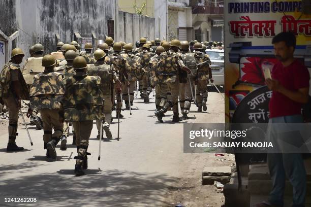 Members of Indian security personnel keep vigil during the demolition of the illegal structures of the residence of Javed Ahmed, a local leader who...