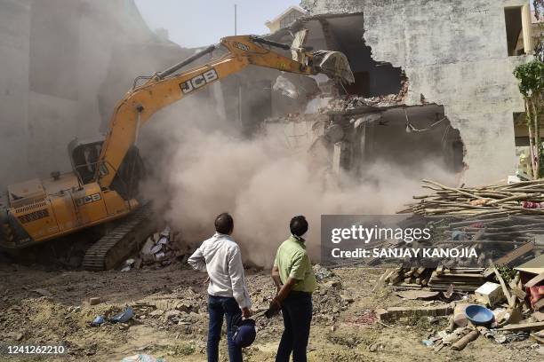 Bulldozer is being used to demolish the illegal structures of the residence of Javed Ahmed, a local leader who was allegedly involved in the recent...