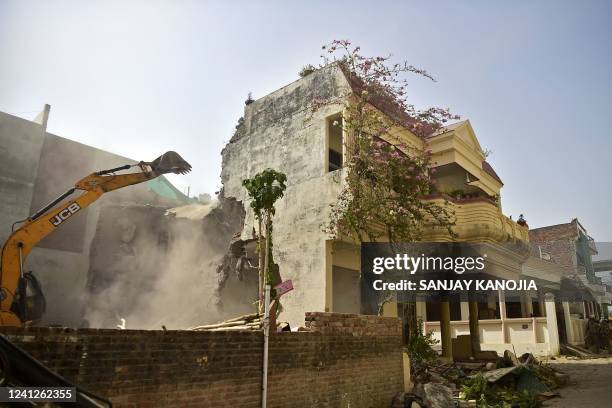 Bulldozer is being used to demolish the illegal structures of the residence of Javed Ahmed, a local leader who was allegedly involved in the recent...