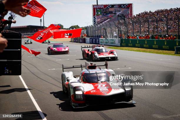 Race winners the Toyota Gazoo Racing GR010 Hybrid of Sebastien Buemi, Brendon Hartley, and Ryo Hirakawa at the end of the Le Mans 24 Hours Race on...