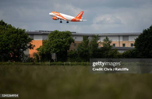 Plane takes off above Brook House Immigration Removal Centre on June 12, 2022 in London, England. Under a new policy, the UK government will fly some...