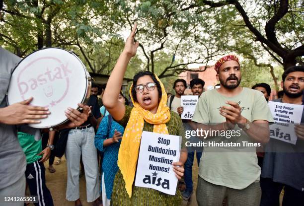 Members of JNUSU protest against the demolition of houses using bulldozers in Uttar Pradesh, at JNU campus, on June 12, 2022 in New Delhi, India. A...