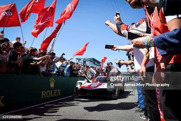 Race winners the Toyota Gazoo Racing GR010 Hybrid of Sebastien Buemi, Brendon Hartley, and Ryo Hirakawa celebrate entering parc ferme at the Le Mans...