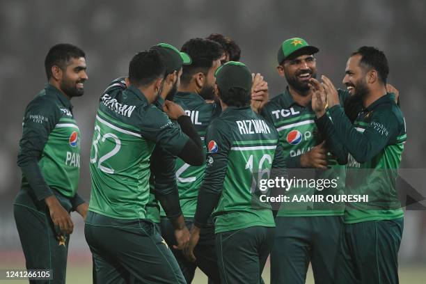 Pakistan's Mohammad Nawaz celebrates with teammates after taking the wicket of West Indies' captain Nicholas Pooran during the third and final...