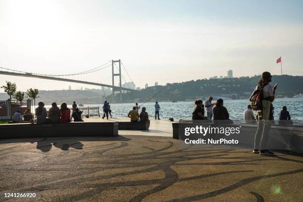 People are resting on the Bosphorus in Istanbul, on june 11, 2022.