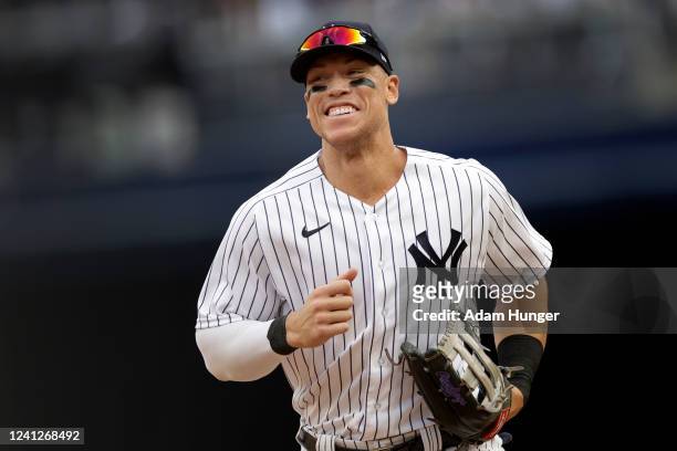 Aaron Judge of the New York Yankees smiles as he runs to the dugout against the Chicago Cubs during the sixth inning at Yankee Stadium on June 12,...