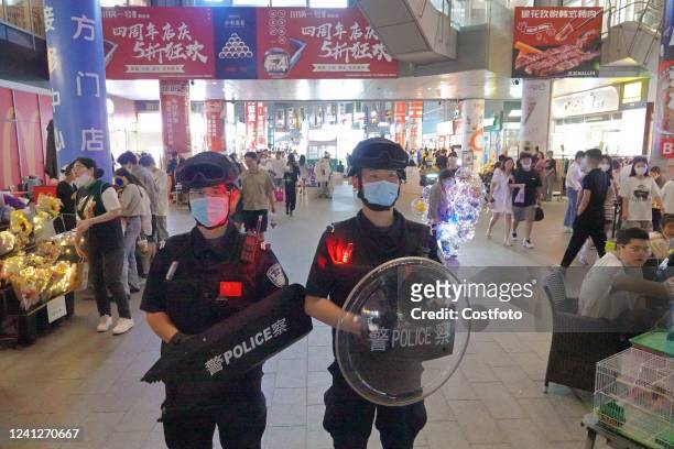 Special police officers are on duty at a night market in Laishan District of Yantai, East China's Shandong Province, June 12, 2022. In the early...