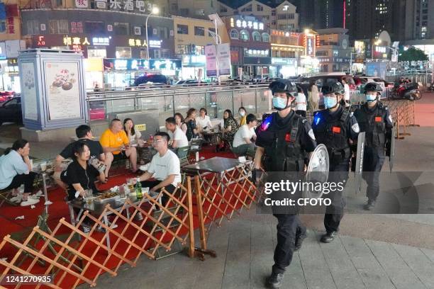 Special police officers are on duty at a night market in Laishan District of Yantai, East China's Shandong Province, June 12, 2022. In the early...