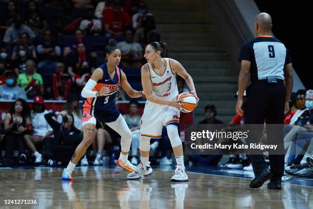 Natasha Cloud of the Washington Mystics plays defense on Diana Taurasi of the Phoenix Mercury drives to the basket on June 12, 2022 at Entertainment...