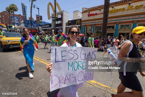 Woman protests gun violence on Hollywood Boulevard in the annual Pride Parade on June 12, 2022 in the Hollywood section of Los Angeles, California....