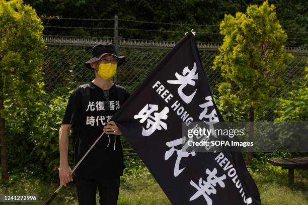 Demonstrator holds a "Free Hong Kong" flag during the three year anniversary of the June 12, 2019 Hong Kong protest. June 12, 2022 marks the three...