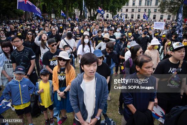 Pro-democracy demonstrators sing during a rally at Parliament square in London to mark the third anniversary of the start of massive pro-democracy...