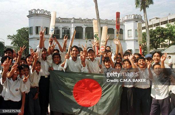 Students of Wills Little Flower School in downtown Dhaka show V sign with Bangladesh flag after authorities suspended classes to allow students to...