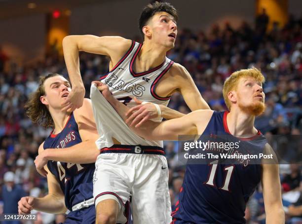 To R: St. Mary's Gaels guard Alex Ducas , Gonzaga Bulldogs center Chet Holmgren , and St. Mary's Gaels forward Matthias Tass position themselves for...