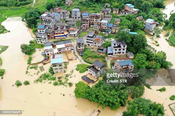 This aerial photo taken on June 13, 2022 shows flooded fields and buildings following heavy rains in Rongan in China's southern Guangxi region. /...