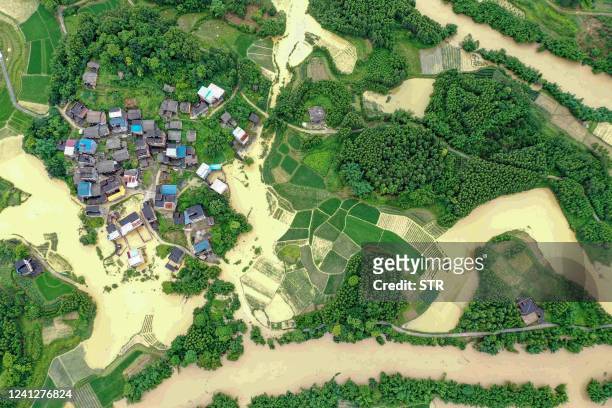 This aerial photo taken on June 13, 2022 shows flooded fields and buildings following heavy rains in Rongan in China's southern Guangxi region. /...