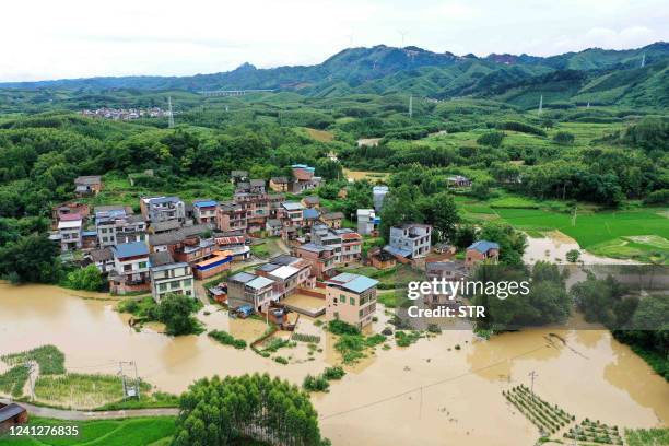 This aerial photo taken on June 13, 2022 shows flooded fields and buildings following heavy rains in Rongan in China's southern Guangxi region. /...