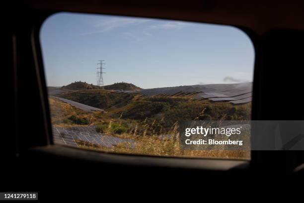 Photovoltaic panels, which form part of the Solara 4 solar park, near a high voltage electricity power line in Vaqueiros, Faro district, Portugal, on...