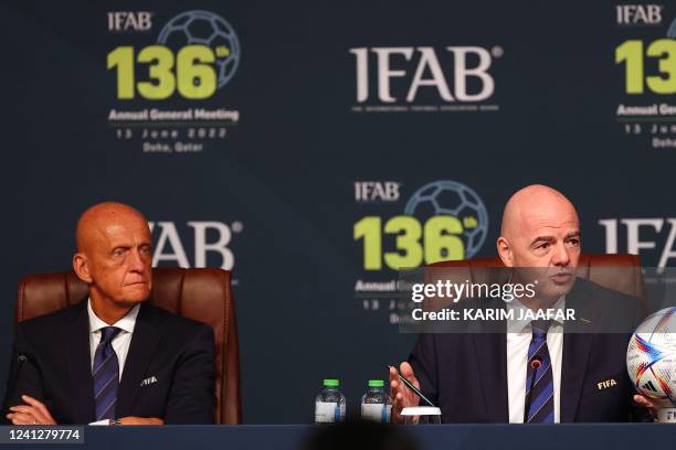 President Gianni Infantino speaks as FIFA referees committee chairman Pierluigi Collina looks on during the 137th International Football Association...