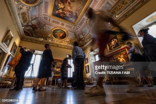 Visitors attend a press preview of the exhibition "Titian: Dialogues of Nature and Love" on June 13, 2022 at the Galleria Borghese in Rome. - From...
