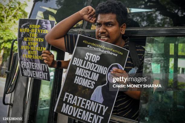 Student displays a placard from inside a vehicle after being detained by the police during a demonstration held outside the Uttar Pradesh Bhawan in...