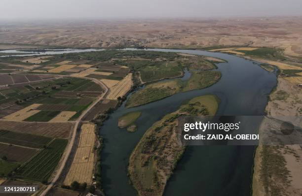 This picture taken on June 12, 2022 shows an aerial view of the Tigris river which is witnessing lower levels of water due to climate change and...