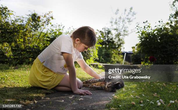 In this photo illustration Girl with domestic cat on May 09, 2022 in Bonn, Germany.