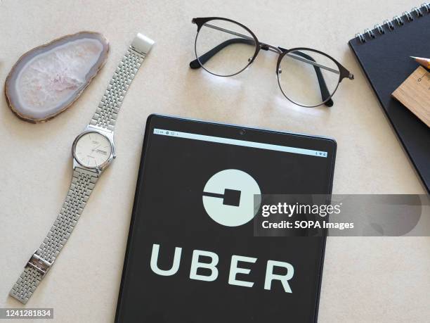 In this photo illustration, the Uber Technologies Inc. Logo seen displayed on a tablet.