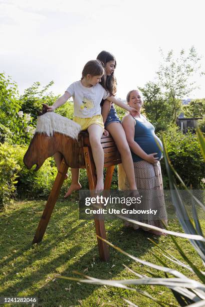 In this photo illustration a pregnant mother with two daughters on May 09, 2022 in Bonn, Germany.