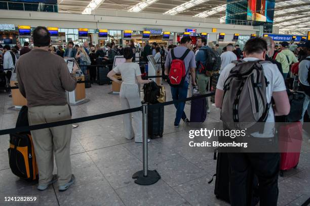 Passengers queue to check in at the departures hall of Terminal 5 at London Heathrow Airport in London, UK, on Monday, June 13, 2022....