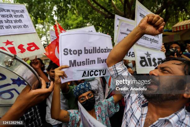 Protestors shout slogans during a protest against the state government for demolishing the house of a local Muslim leader in Prayagraj, following...