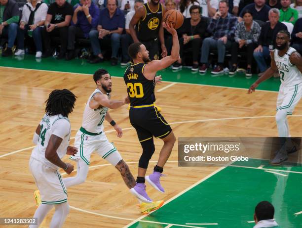 Golden State Warriors guard Stephen Curry makes a running floater in the lane against the Boston Celtics during fourth quarter action. The Boston...