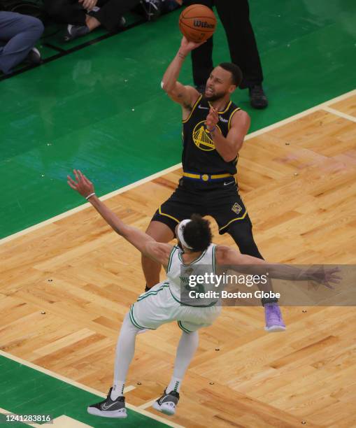 Golden State Warriors guard Stephen Curry picks up an offensive foul as he knocks over Boston Celtics guard Derrick White during second quarter...